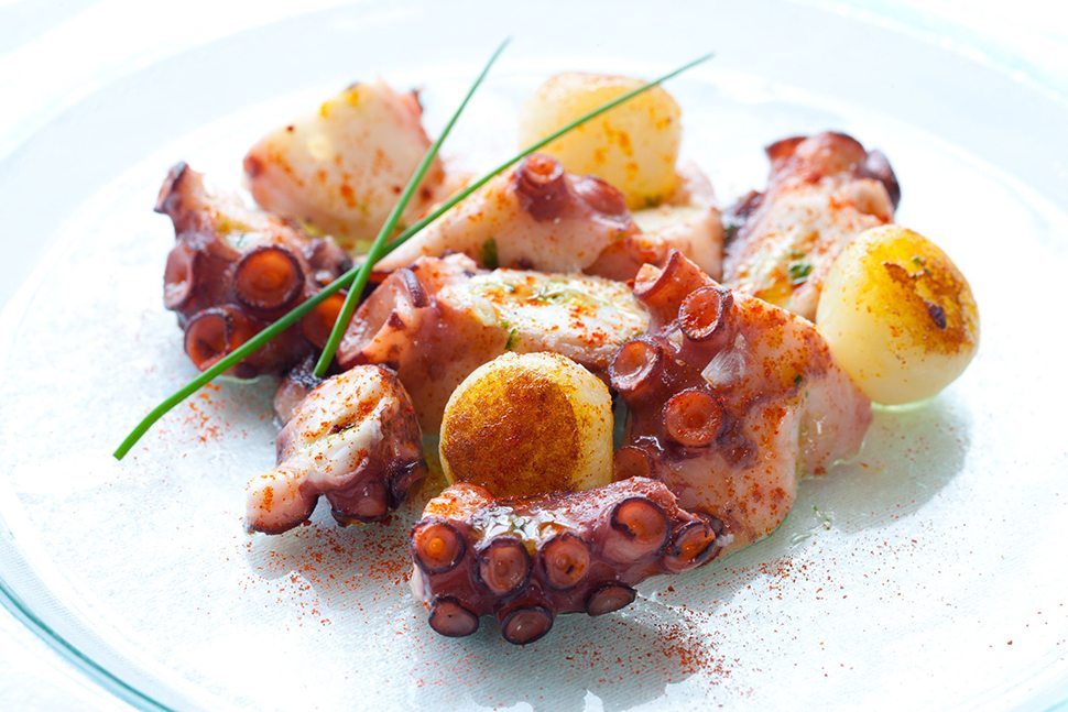 13873074 - macro close up of octopus appetizer with small potatoes.