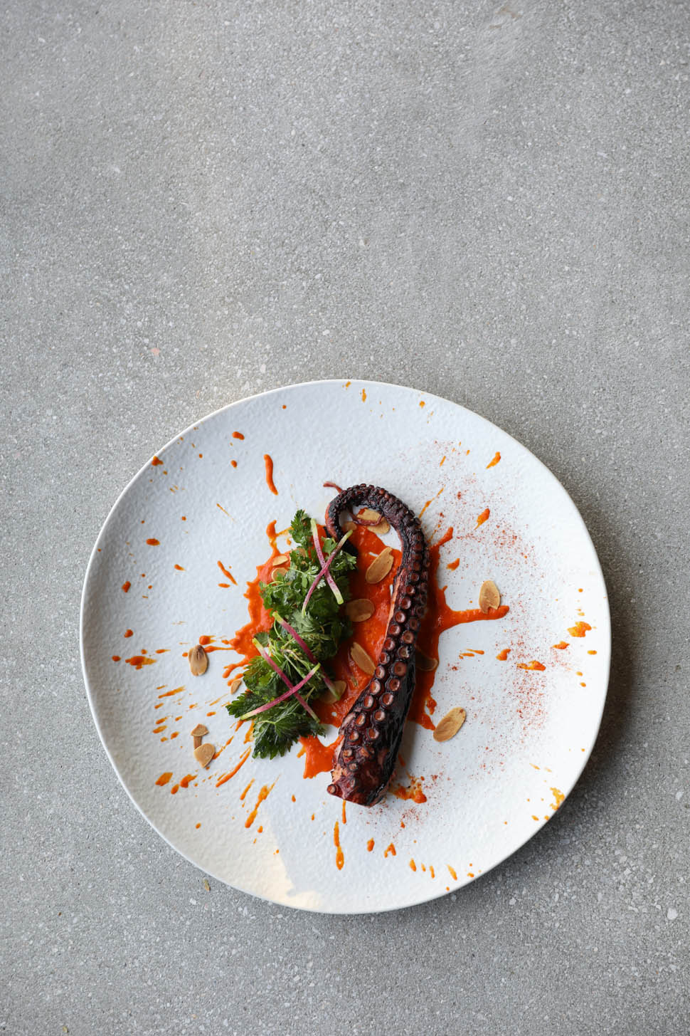 3 Grilled octopus with romesco sauce wild green and toasted almonds