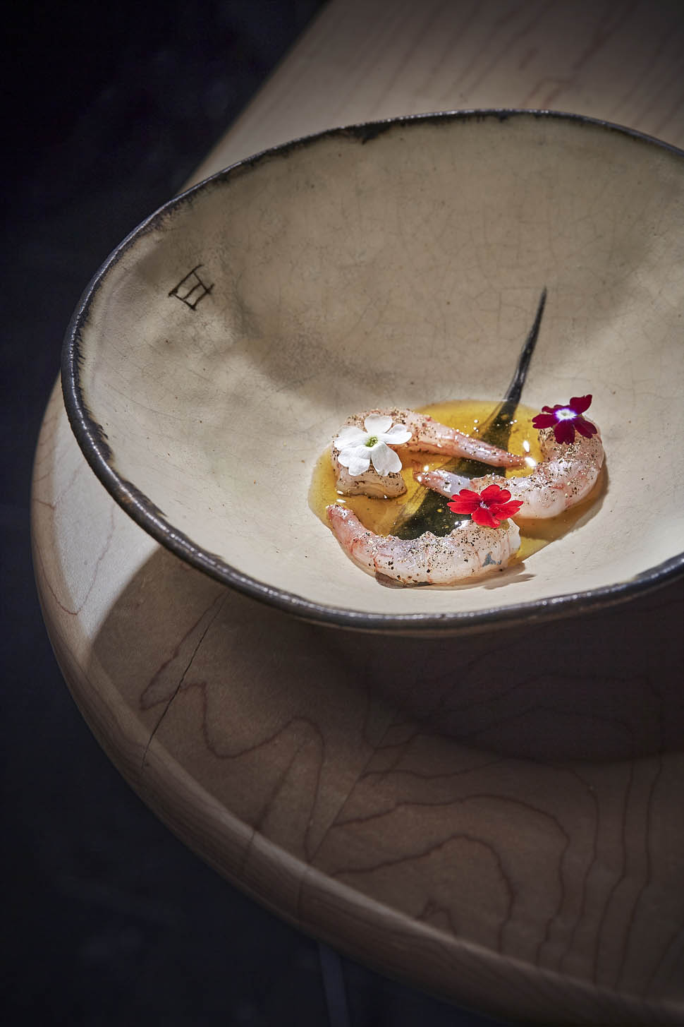 Motril shrimp served with grilled brown butter smoked black pepper and yuzu kosho to preserve their creaminess and enhance their flavor1