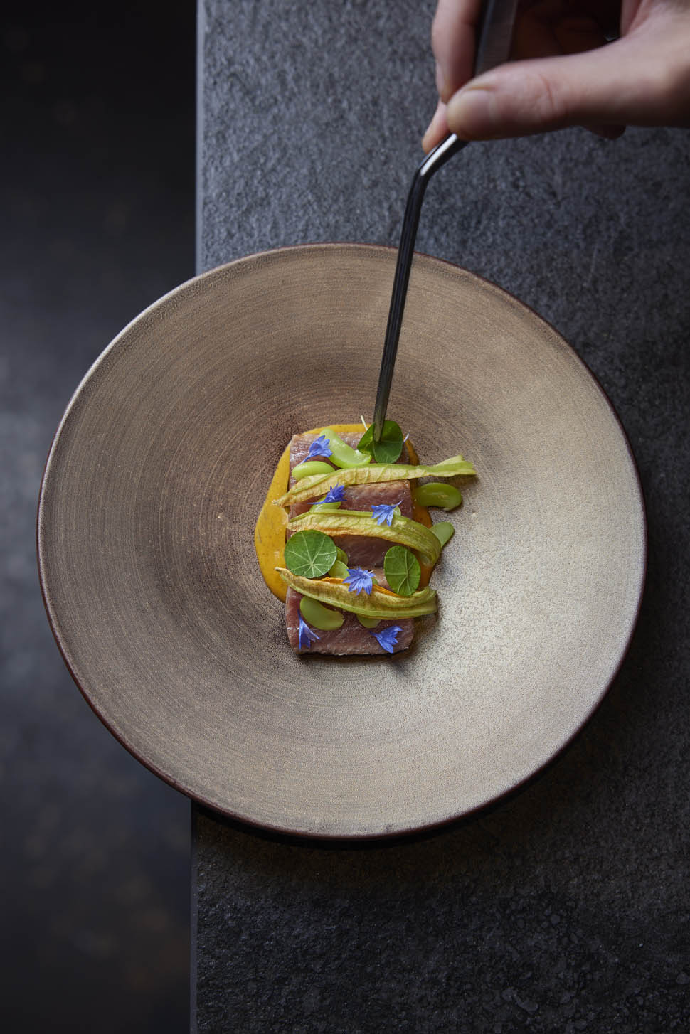 Saku belly rubs grilled red tuna served with a Bouillabaise emulsion butter and saffron